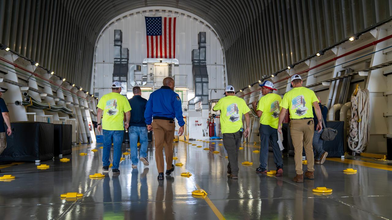 NASA astronaut Victor Glover views the core stage of the SLS (Space Launch System) rocket that will help power Artemis II at NASA’s Michoud Assembly Facility in New Orleans July 15. Glover will pilot Artemis II, the first crewed mission of NASA’s Artemis campaign. Crews moved the 212-foot-tall core stage with its four RS-25 engines to Building 110 at NASA Michoud prior to rolling it out to NASA’s Pegasus barge July 16 for delivery to NASA’s Kennedy Space Center in Florida. The core stage has two giant propellant tanks that collectively hold more than 733,000 gallons of super cold liquid propellant to feed the stage’s four RS-25 engines. Together, the engines produce more than 2 million pounds of thrust to help send astronauts inside NASA’s Orion spacecraft to venture around the Moon for Artemis II.  NASA is working to land the first woman, first person of color, and its first international partner astronaut on the Moon under Artemis. SLS is part of NASA’s backbone for deep space exploration, along with the Orion spacecraft, supporting ground systems, advanced spacesuits and rovers, the Gateway in orbit around the Moon, and commercial human landing systems. SLS is the only rocket that can send Orion, astronauts, and supplies to the Moon in a single launch.  